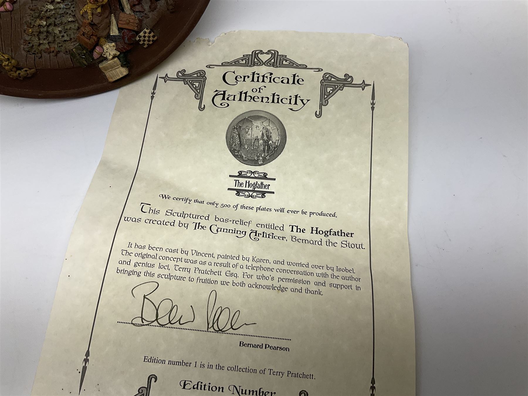 Two Terry Pratchett Discworld limited edition sculptured bas-reliefs, designed by Clarecraft, comprising Death Study created by 'the cunning artificer, Bernard the stout', 132/500 and The Hogfather, created by 'the cunning artificer, Bernard the stout', 132/500, both with certificates of authenticity.   