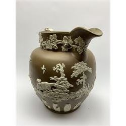 Large 19th century Jasperware jug, of exhibition size, probably Wedgwood or Copeland Spode, the brown ground decorated with hunting scene frieze of hounds chasing game birds and rabbit, the base and and scrolling handle with foliate detail, the rim with fruiting vine, H35cm