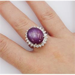 Platinum cabochon star ruby and round brilliant cut diamond cluster ring, stamped Pt900, ruby 12.57 carat, total diamond weight 0.88 carat