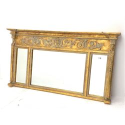 Regency style gilt wall mirror, scrolled foliate and mask decorated frieze over three sectional mirror glazed with bevelled glass, 140cm x 75cm