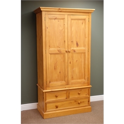  Solid pine double wardrobe, projecting cornice, two doors enclosing hanging rail above two short and one long drawer, plinth base, W100cm, H192cm, D54cm  