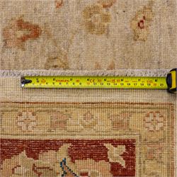 Indo-Persian Ziegler style Farahan design hand-knotted wool carpet, ivory field with open composition with dispersed palmettes, floral sprays and scrolling vinery with central subtle medallion enclosed within deep madder red border of complementary stylized foliate motifs