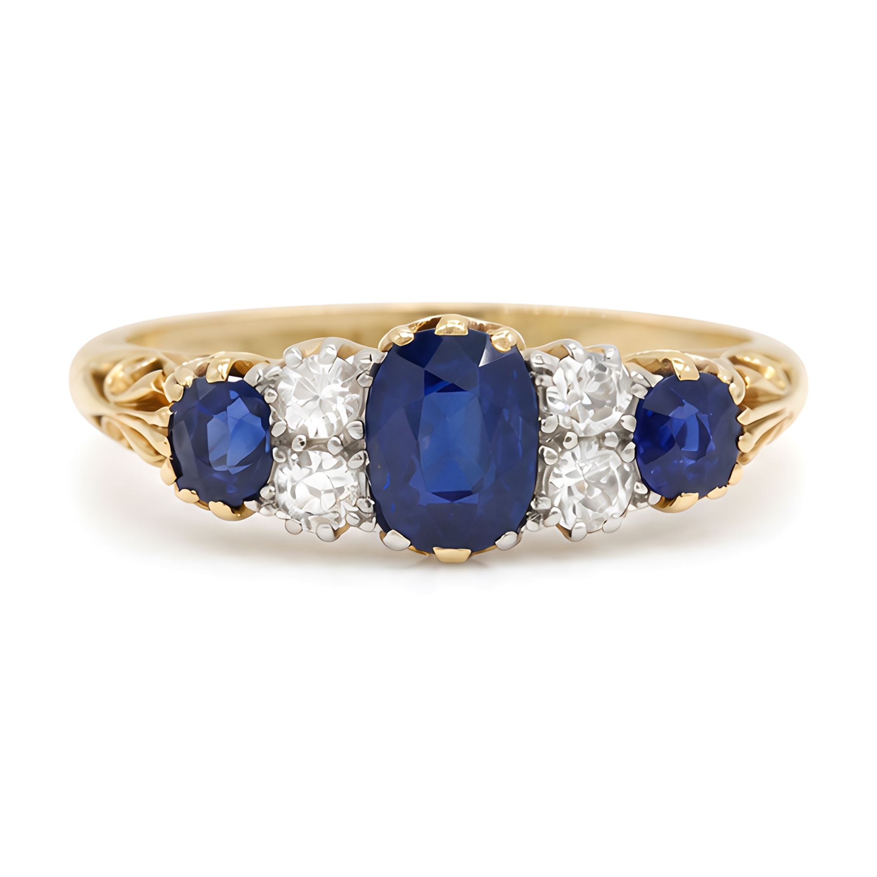 Early 20th century gold sapphire and diamond ring, three vari-cut sapphires, spaced by four old cut diamonds, with scroll design shoulders, stamped 18ct, total sapphire weight approx 1.45 carat, total diamond weight approx 0.30 carat