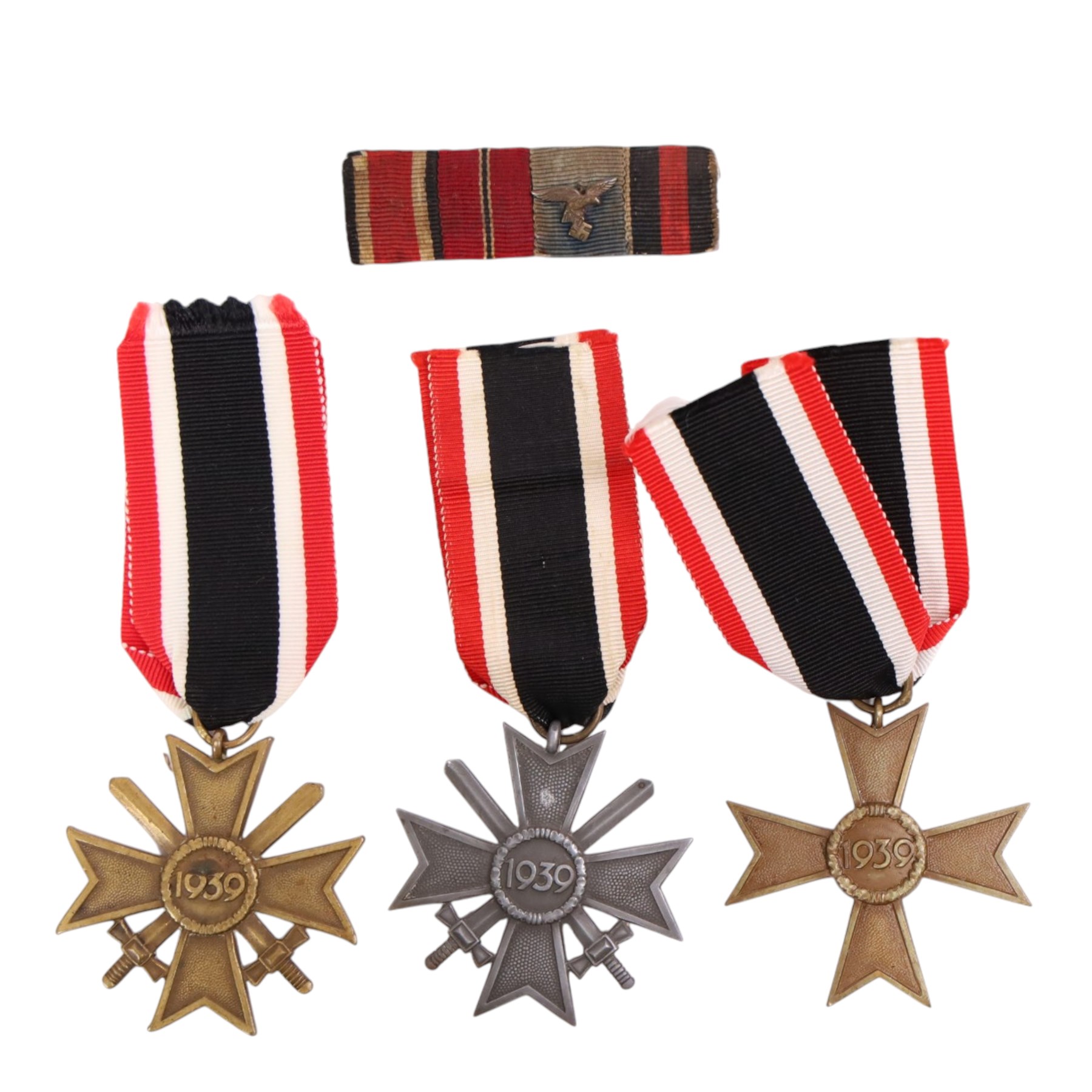 WWII Third Reich three War Merit Crosses, two with swords, together with a four piece medal bar with eagle 