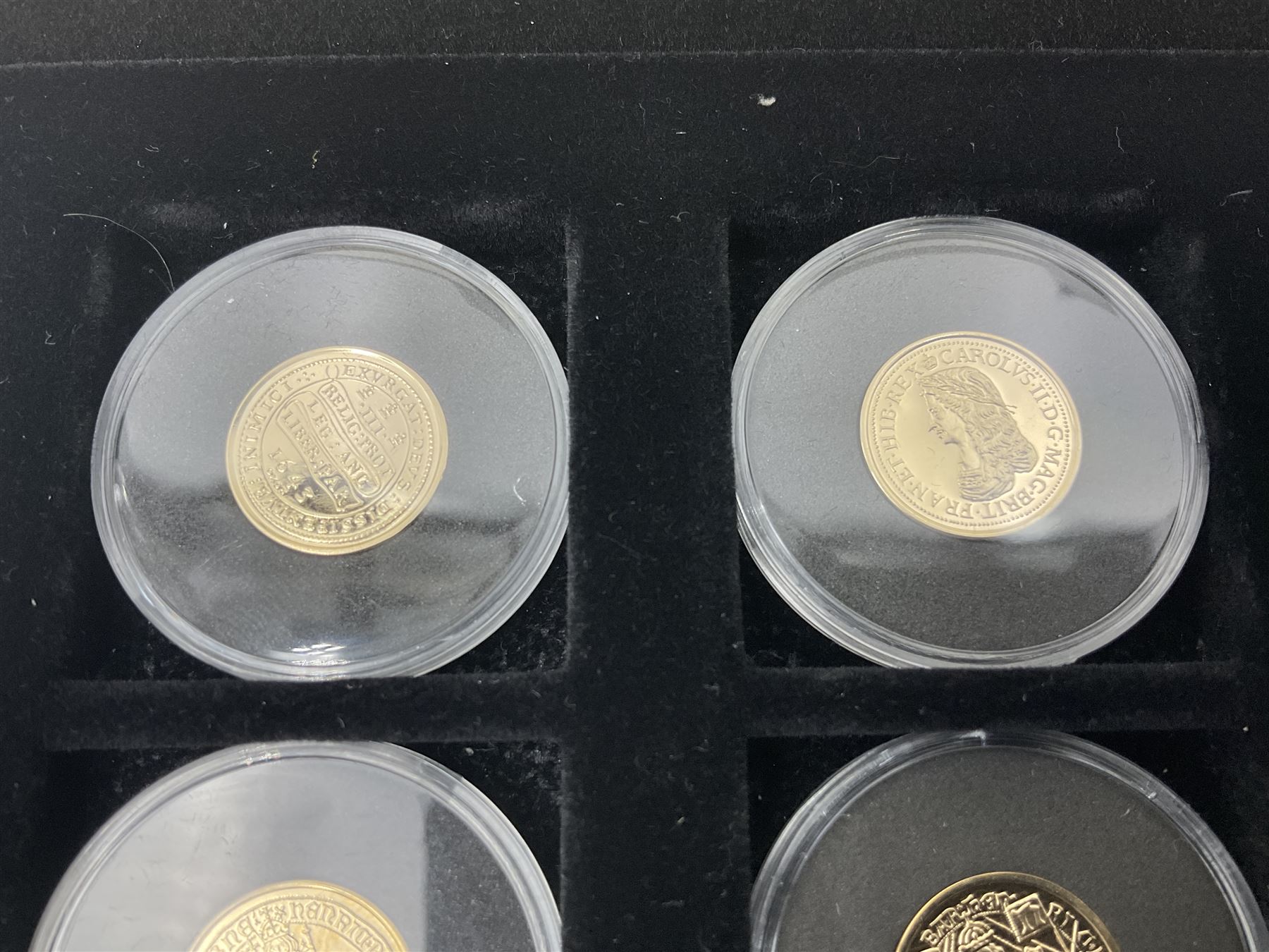 Sixteen hallmarked 9ct gold replica coins from 'The Historic Coins Of Great Britain Museum Gold Collection', housed in a Westminster display case, overall weight approximately 51.3 grams