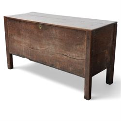 Large late 17th Century oak coffer, the hinged lid with twin rear strap hinges above a plain front with inset brass escutcheon, raised on square supports with pegged joinery and displaying pronounced grain figuring to the single front board