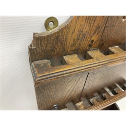 George III oak spoon rack and candle box, the rectangular backplate with shaped  pediment and two six aperture spoon racks, above a candlebox with hinged cover, with various brass spoons and a pair of brass candle snuffers, H56.5cm, W35cm, D14cm 