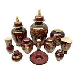 Two Crown Devon Rouge Royale pattern large temple jars with temple dog finial to lid, together with seven other Crown Devon ceramics and two lidded Carlton Ware temple jars in Red Royale, tallest example H47cm (11)