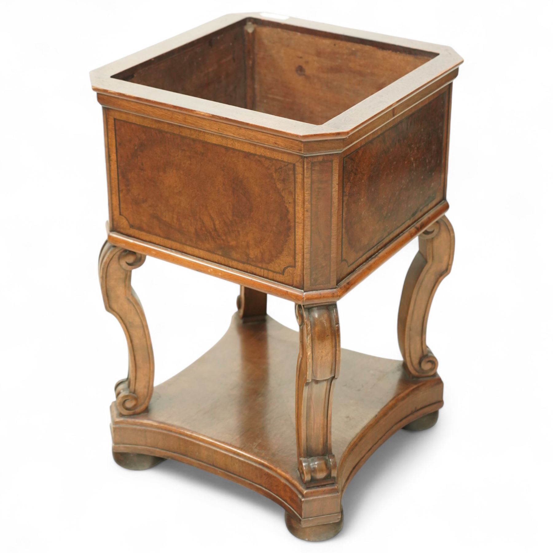 Edwardian style walnut jardiniere stand, of square form, with burr walnut veneered side panels on scroll carved supports on a shaped plinth base 