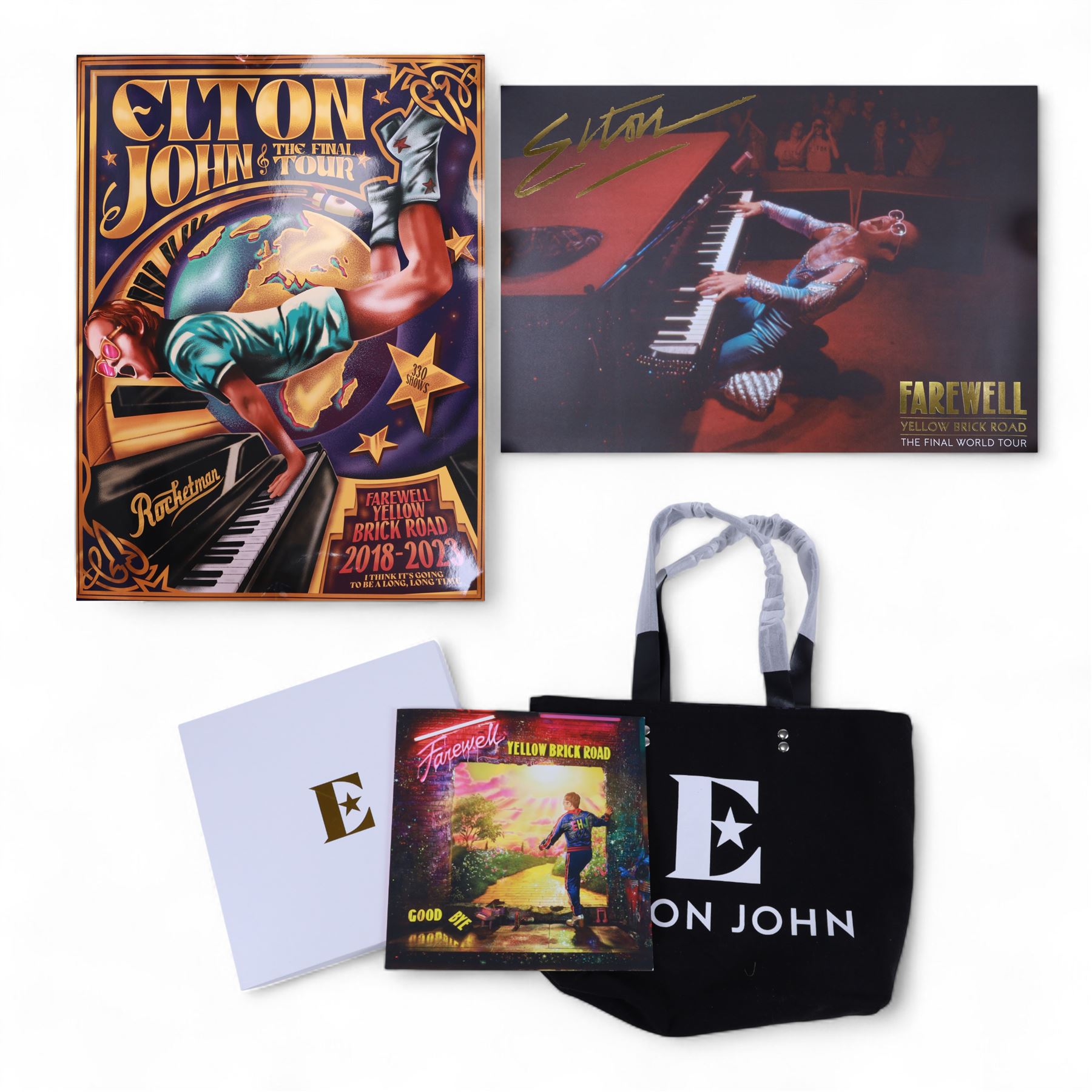 Elton John Farewell Yellow Brick Road tour merchandise, comprising programme, tote bag and VIP giftset with lanyard, wallet, luggage tag and keyring, in white box with gilt lettering, together with two limited edition Farewell Yellow Brick Road lithographs
