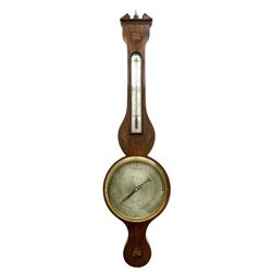William IV early 19th century mercury wheel barometer with an inlaid broken pediment, brass finial and round base, mahogany veneered case with inlaid oval conch shell paterae and satinwood stringing to the edge, with an arched top thermometer box and spirit thermometer measuring degrees Fahrenheit from 15 to 110, eight-inch silvered register reading barometric pressure in inches from 28  to 31, with predictions in Roman upper and lower case and script, dial inscribed “William Smith, Crowland”, with a steel indicating hand, brass recording hand and cast brass bezel.
.


