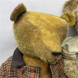 Two early 20th century straw filled jointed teddy bears, first example wearing a tweed jacket bearing Geoffrey Saville label, with leather padded paws and ears, horizontally stitched nose and humpback; second example with applied eyes, vertically stitched nose and faux leather paw pads, both with growler mechanisms, tallest H74cm 