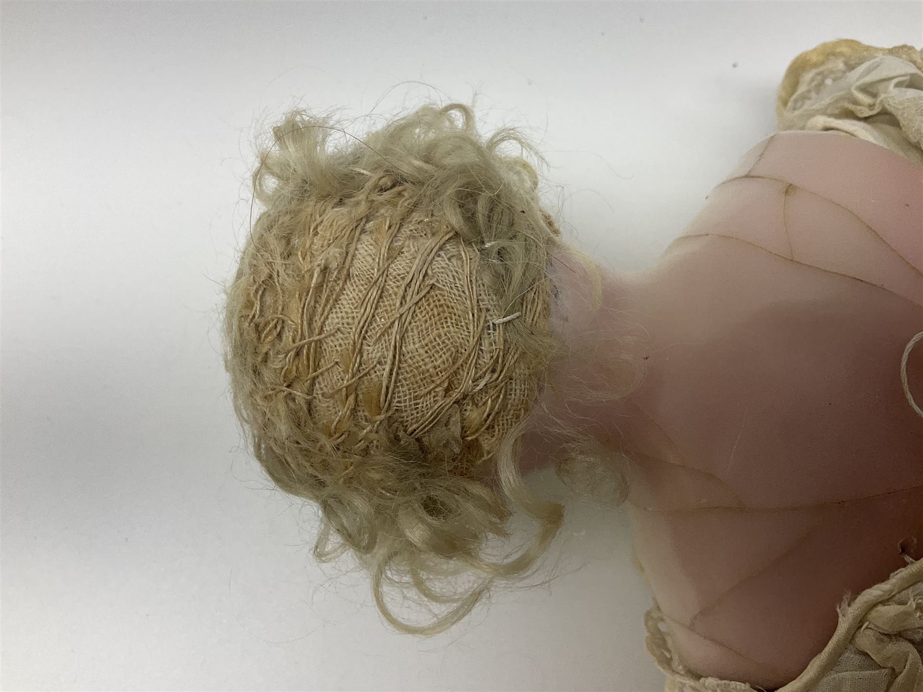 Victorian wax shoulder head doll with pale complexion, applied hair, inset glass eyes and fabric covered jointed body with kid leather lower arms; white linen dress and undergarments H50cm