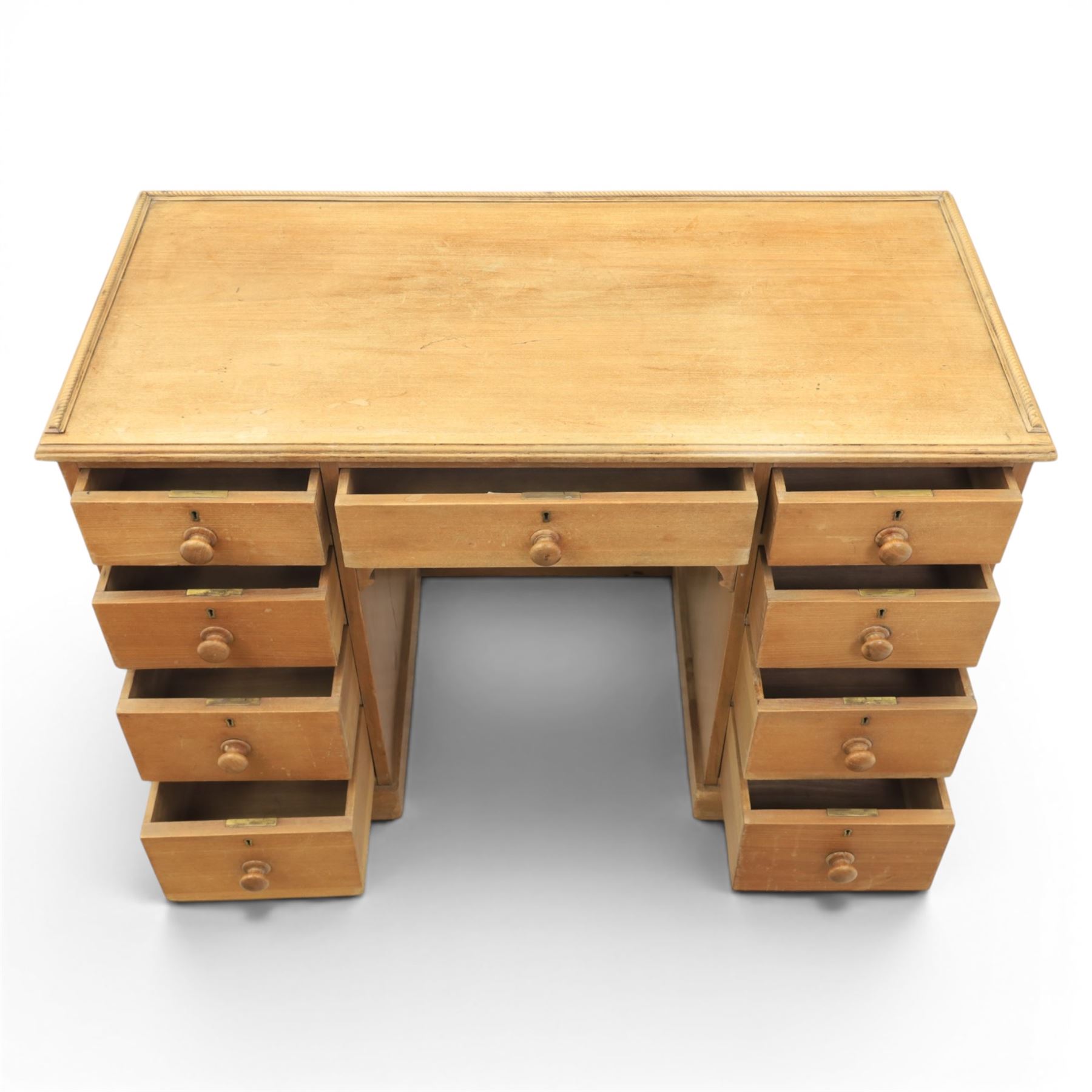20th century ash twin pedestal desk, gadroon galleried top, twin bank of graduated drawers, plinth base