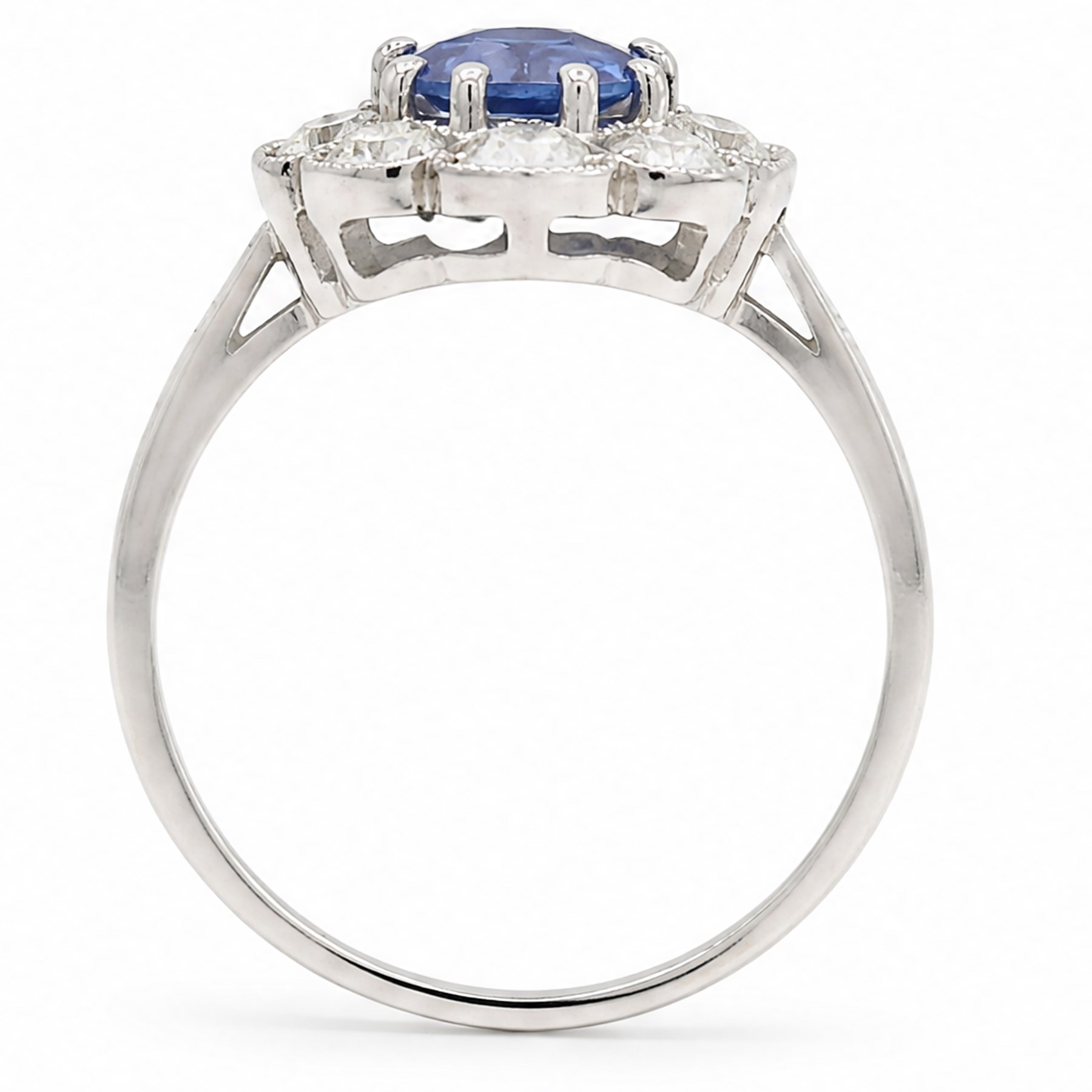 Platinum sapphire an diamond cluster ring, single modified cushion cut sapphire of approx 1.40 carat, surrounded by milgrain set round brilliant cut diamonds and baguette diamond shoulders, hallmarked, total diamond weight approx 0.80 carat