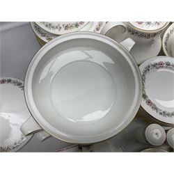 Royal Albert Paragon tea and dinner service for twelve decorated in the Belinda pattern, comprising fourteen saucers, twelve teacups, thirteen side plates, teapot, sauce boat and stand, salt and pepper shakers, two jugs, sucrier, twelve dinner plates, twelve smaller plates, two lidded tureens, twelve bowls, twelve smaller bowls, cake plate, oval plate and oval dish (100)