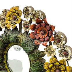Circular metal work wall mirror, plain mirror plate surrounded by flowers and foliage 