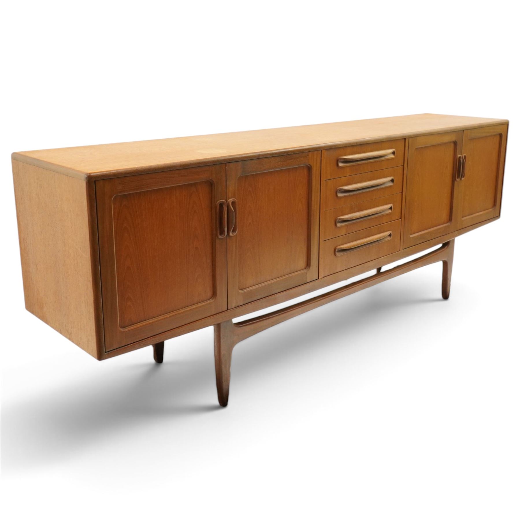 G-Plan - 'Fresco Long John' teak mid 20th century sideboard, a central bank of four drawers, flanked by twin cupboard doors, with recessed handles, on a tapering supports 