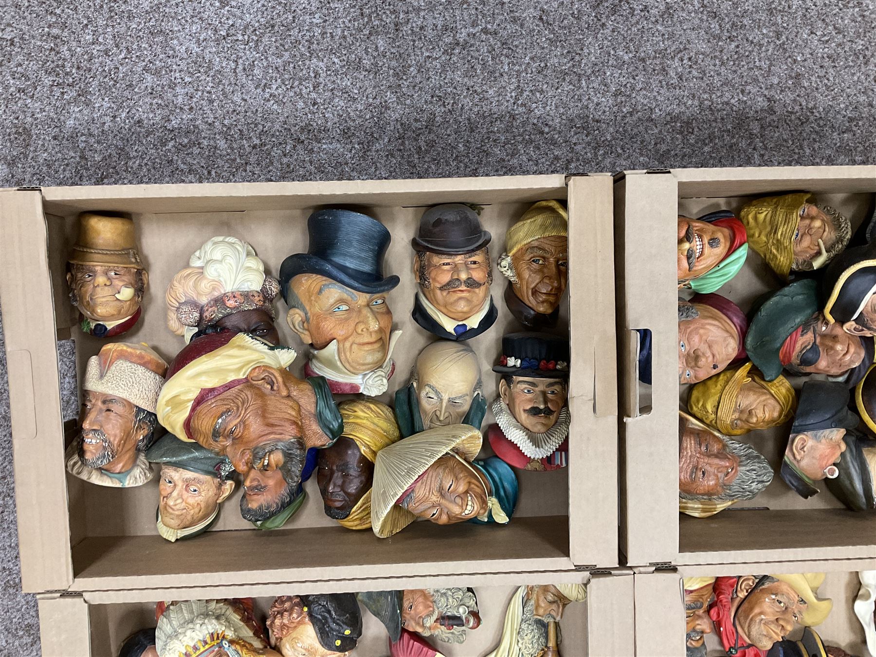 Large collection of Bossons plaster wall-masks, including including fisher man, cowboys, native Americans, etc, in four boxes 