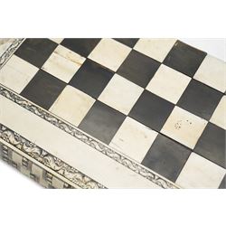 Mid-19th-century Anglo Indian Vizagapatam ivory, sandlewood, and horn veneered backgammon/chess board, circa 1860, rectangular games box the borders engraved with a stylized scrolling leaf decoration and spine engraved History of Persia the interior inlaid for backgammon, with three internal sandalwood boxes with covers, containing 16 ivory pieces and 16 horn pieces, comprising, kings and queens with pierced crowns on baluster carved shafts; bishops with carved mitres; knights represented by horses’ heads; and rooks as towers with imbricated decoration.

This item has been registered for sale under section 10 of the APHA Ivory Act, submission reference G68PNYA5 

