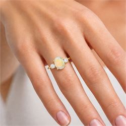 18ct god opal and diamond three stone ring, single oval cabochon cut opal of approx 2.80 carat, with a round brilliant cut diamond set either side, hallmarked, total diamond weight approx 0.25 carat