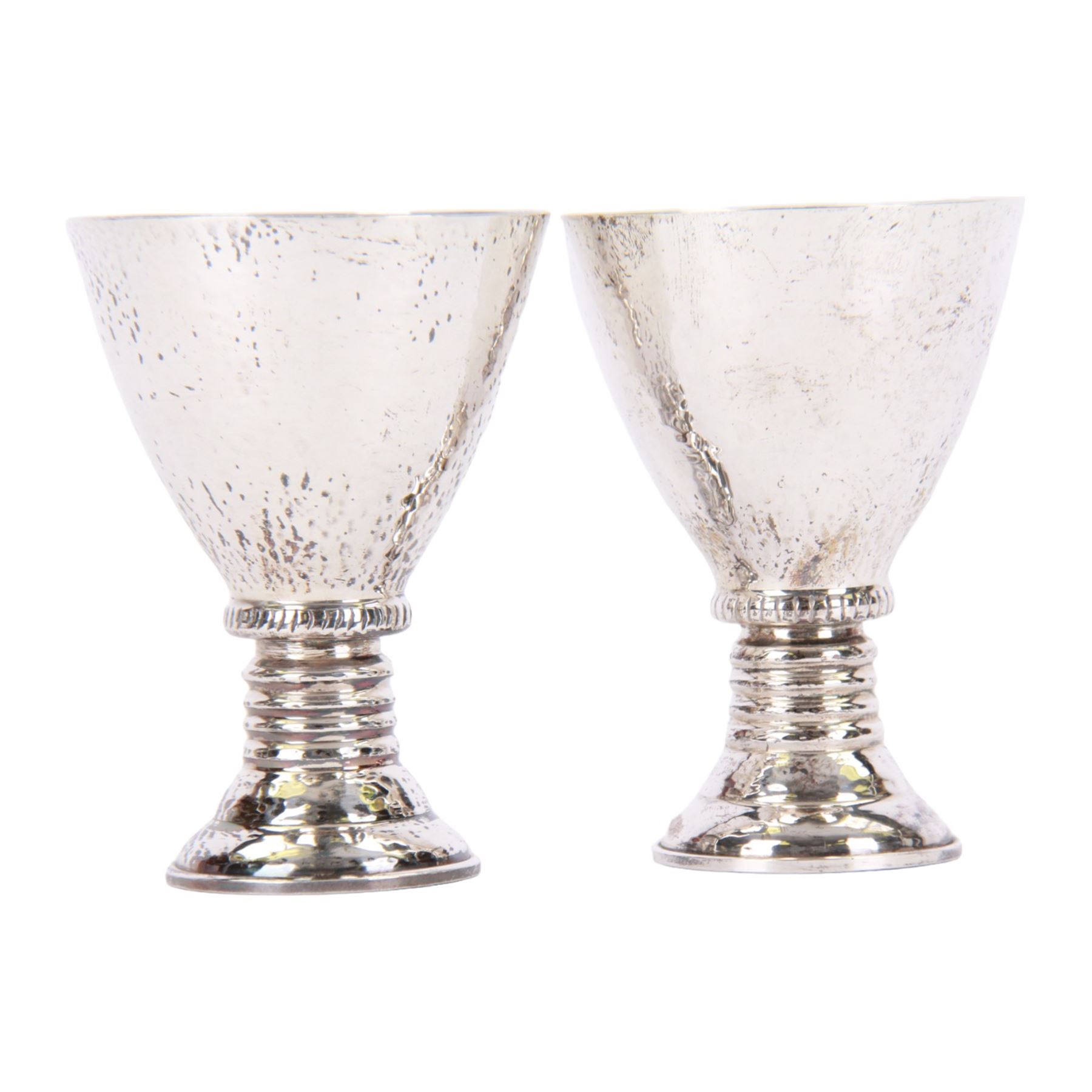 Pair of 20th century Greek silver metal goblets, each with planished tapering bowl upon a knopped stem and stepped spreading foot, marked Lalaounis 925, H10.5cm

