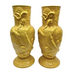Pair of 20th century large floor standing vases with decorated in relief on yellow ground, depicting a dragon in a cloudy sky, with crackle glazing, H64cm