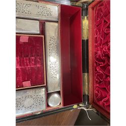  Victorian brass inlaid rosewood dressing table box, retailed by F.L. Hausburg, Liverpool, the lid centred by a brass cartouche, opening to reveal letter store to lid underside, above a fitted interior, with ten mounted cut glass jars, bottles and manicure set, within lift out leather trays, above jewellery drawer, with key, H17cm D24cm