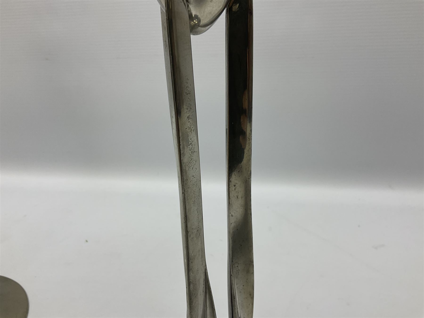 Archibald Knox (1864-1933) for Liberty & Co, pair of Tudric pewter candlesticks, the bud shaped sockets raised upon three angular fin supports and a slightly domed circular base with cast stylised foliate decoration, each stamped beneath Tudric 0223, H30cm