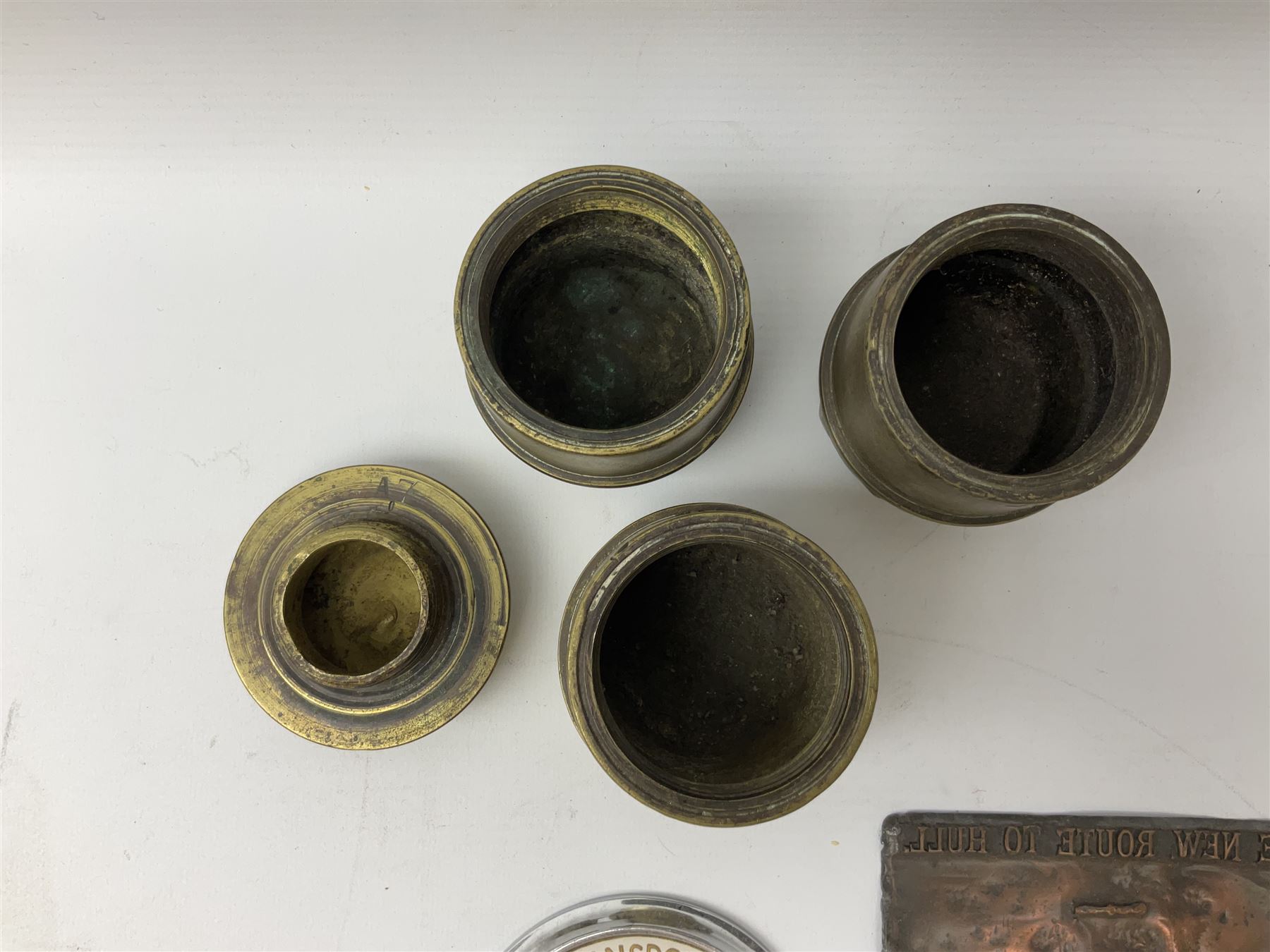 Three brass cart wheel hub caps for W. Johnson & Son Builders Hull, another for W. Harrison Builder Hull, copper printing plate for Hull & Barnsley Railway Timetable, two Hull & District Road Transport Training Group Advanced Driver car badges and framed 1952 car road task disc (8)  