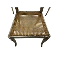 Collection of Regency dining chairs - set of four Regency painted beech dining chairs, with cane seat and back, on collar turned supports with splayed feet (W46cm, H84cm); a pair of Regency ebonised dining chairs (W47cm, H77cm); and a single Regency dining chair, the cresting rail painted with floral cornucopias and central putto vignette, X-frame back over cane seat, on collar turned front supports painted with foliage (W46cm, H84cm) (7)