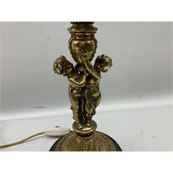 Late 19th/early 20th century brass oil lamp, the central column modelled with two cherubs, supporting the reservoir with wyrthen twist etched floral shade, raised upon circular base