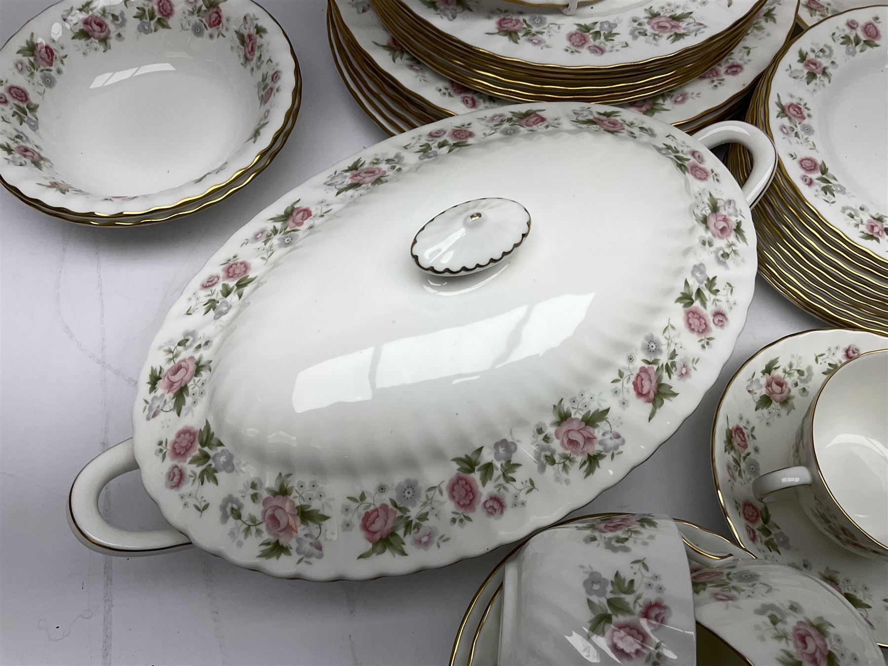 Minton Spring Bouquet pattern dinner and tea service, comprising dinner plates, twin handled tureens with covers, meat platter, teapot, milk jug, sugar bowl with cover, tea cups and saucers, bowls, cake plate, side plates, dessert plates, etc all with printed mark beneath (82)