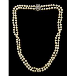 Double strand white / peach / pink cultured pearl necklace, with 18ct white gold round brilliant cut diamond clasp, principal diamond approx 0.30 carat, Birmingham import mark 1964