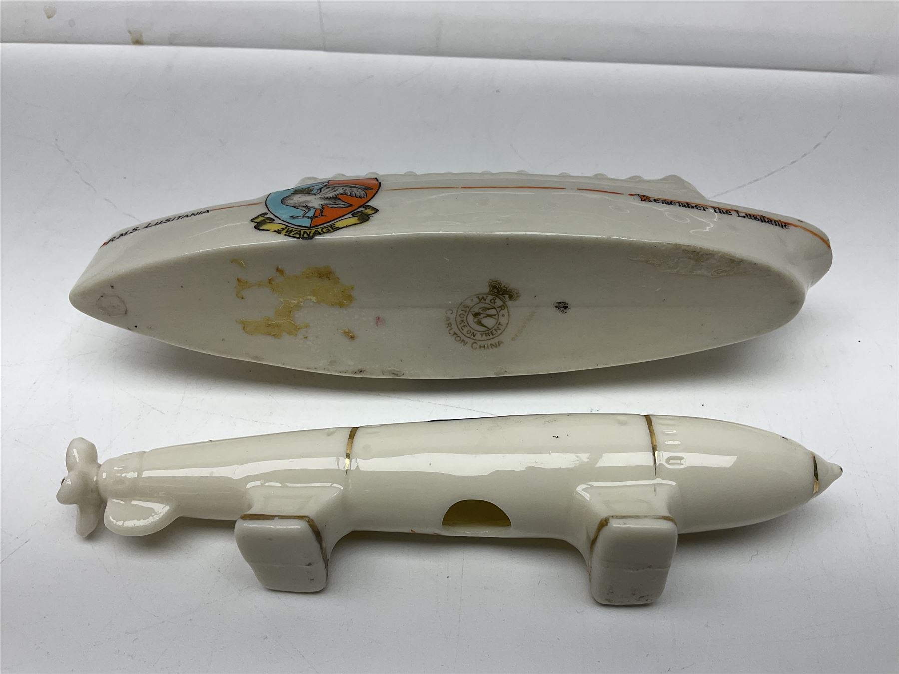 Ten WW1 crested china military models comprising submarine, four ships including Lusitania, four Zeppelins/balloons and an aircraft; various makers including Arcadian China, Swan China, Carlton China, Waterfall, Grafton China etc; various crests including Saint Neots, Great Yarmouth, Tewksbury, Swanage, Simons Town, Hull etc (10)