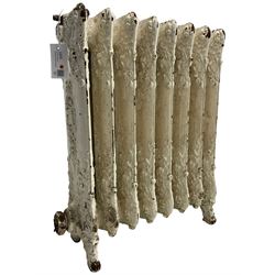 Victorian white painted cast iron radiator, decorated with trailing leafy branches and flowerheads