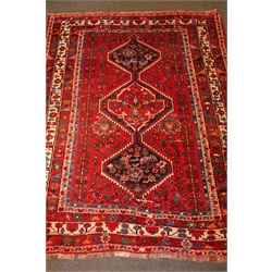  Persian style red ground rug, three central medallions, repeating border, 235cm x 180cm  