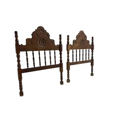 Pair Spanish stained beech single 3' bedsteads, spindle turned backs and carved with scrolling floral decoration 