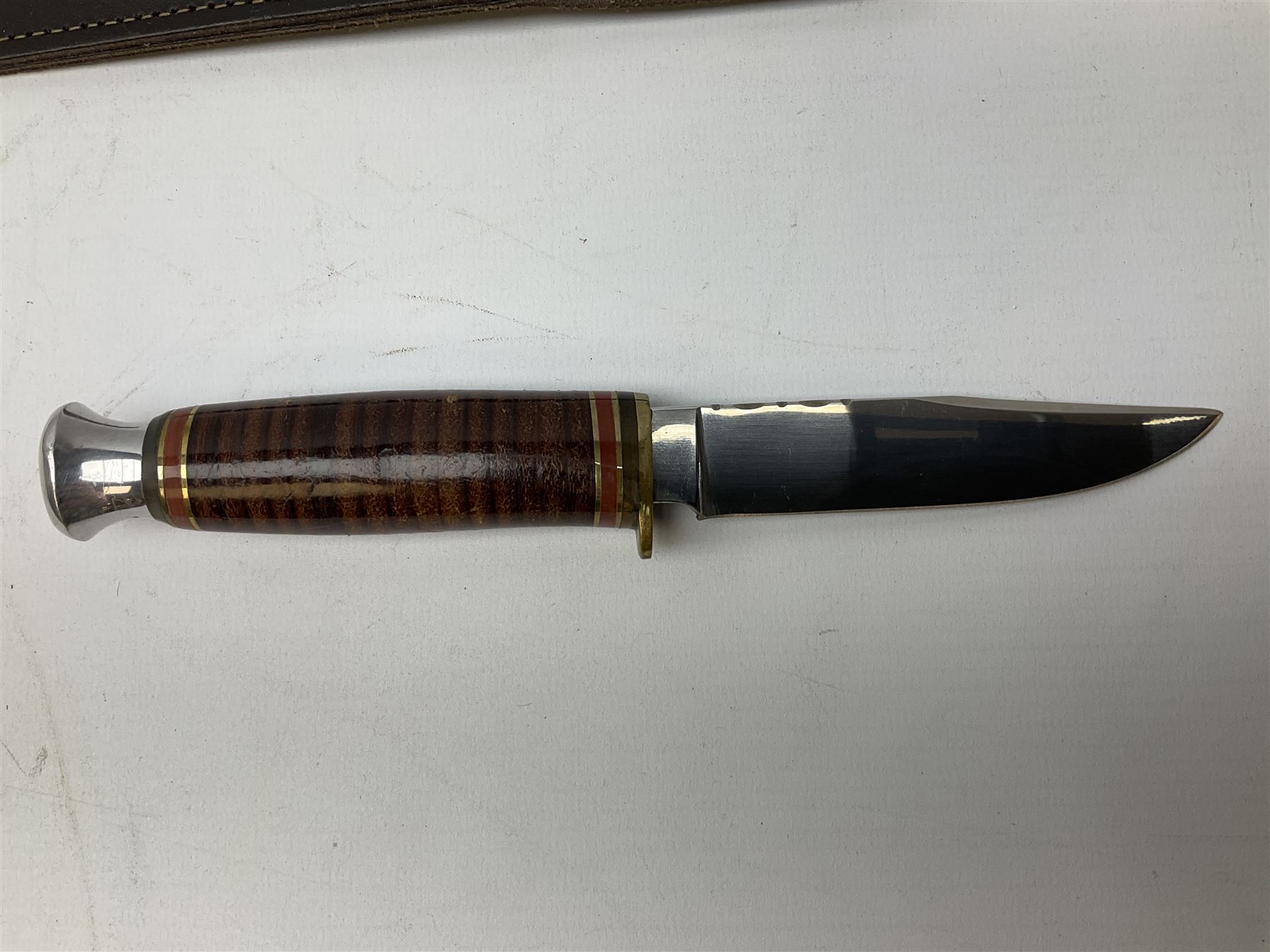 Three hunting knives, each blade marked A. Wright & Sons Sheffield, one with leather handle, one with horn handle and one with antler handle; each with leather sheath (3)