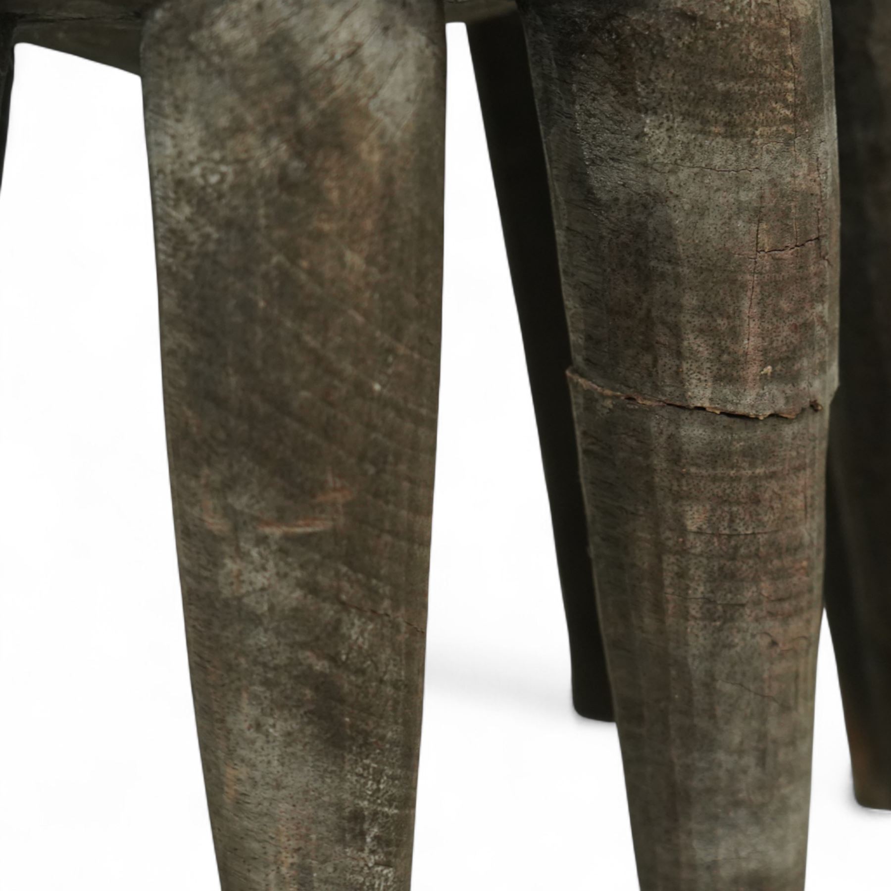 African Nupe carved tribal stool, the rounded top with repeating incised decoration and rope-edge border, supported by ten tapered legs D37cm