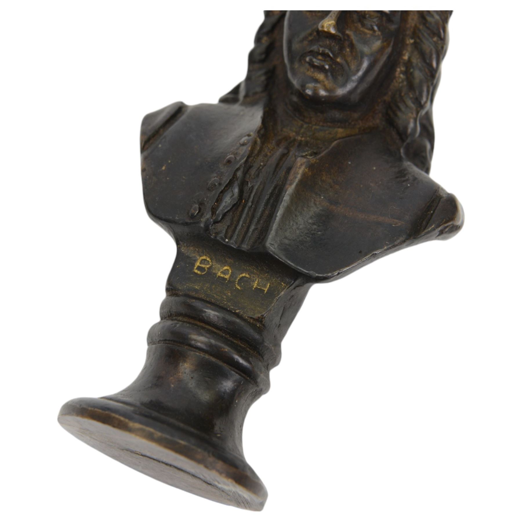 Three small bronze effect brass busts, modelled as composers Beethoven, Bach, and Wagner, each titled and raised upon a socle base, H14.5cm