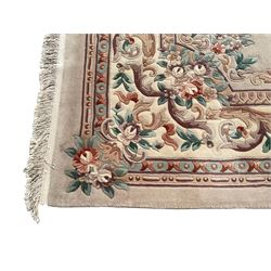 Chinese ivory ground carpet, the central oval medallion surrounding a bouquet, the field decorated with scrolling floral decoration, guarded border with rinceaux, garlands and foliate motifs
