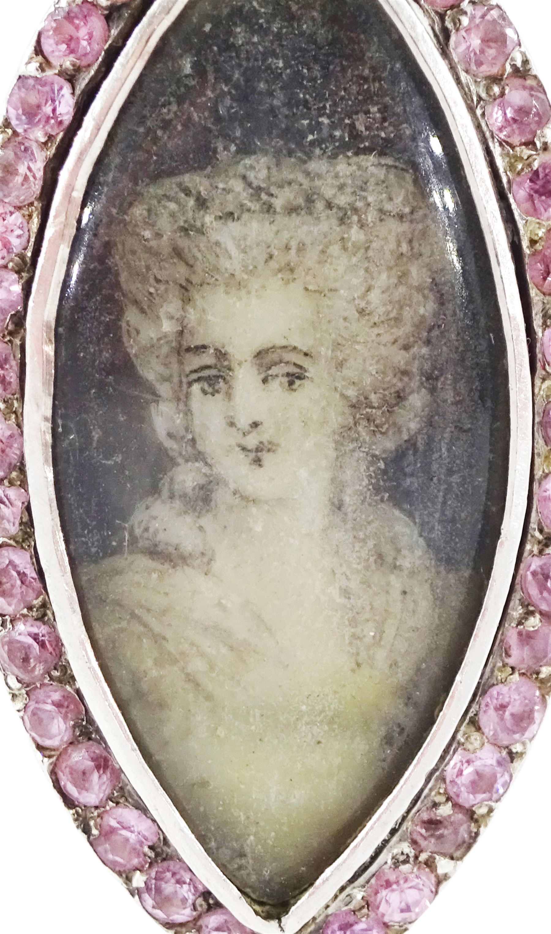 18th / 19th century gold and silver paste stone set portrait ring, the navette bezel set with a miniature of a woman on ivory, under a glazed panel, within a pink paste border and trifurcated shoulders. This lot has been registered for sale under Section 10 of the APHA Ivory Act