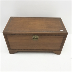 Early 20th century camphor wood chest, single hinged lid with carved foliage detailing, ogee bracket supports, W102cm, H56cm, D51cm