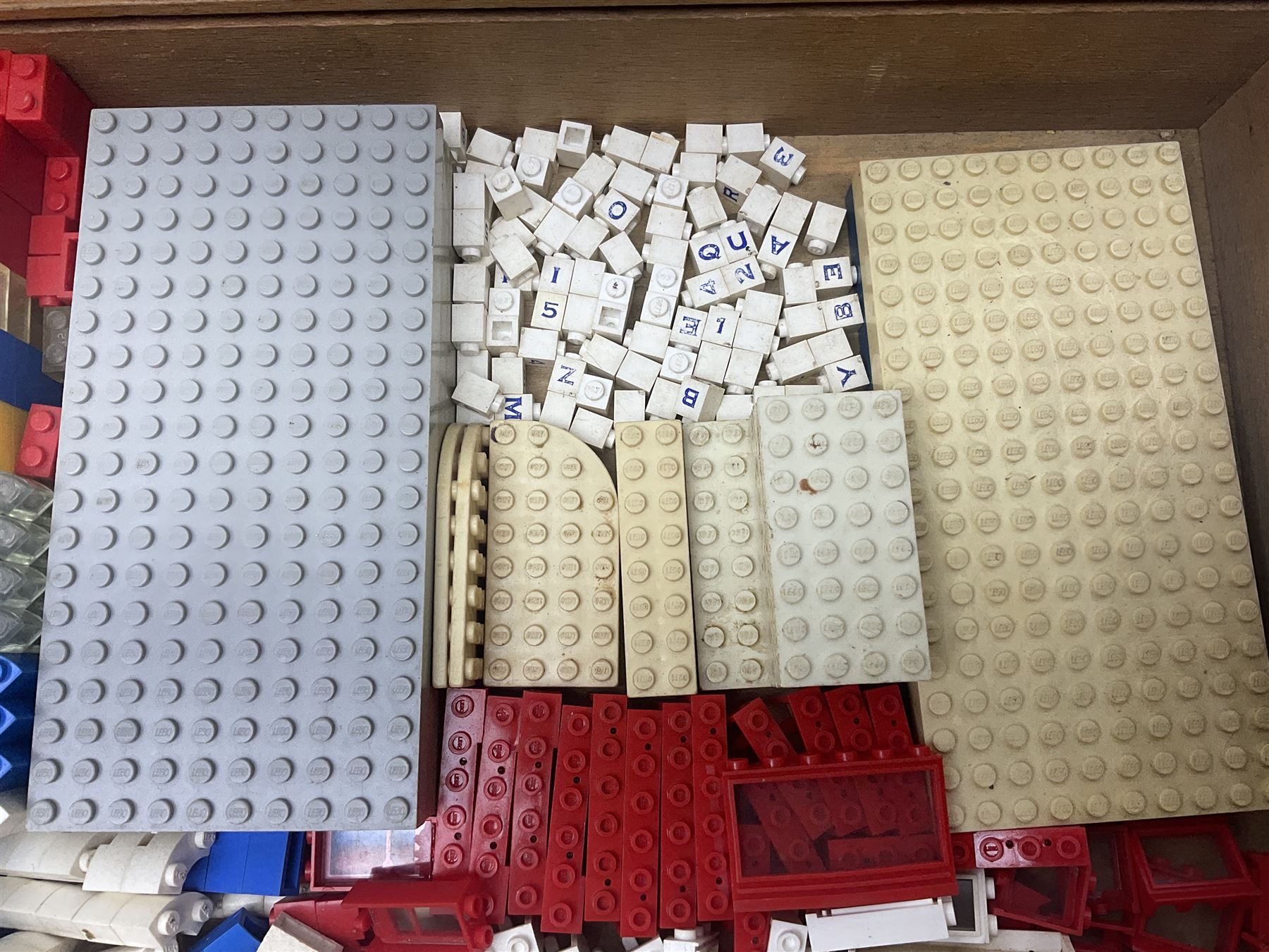 Lego - quantity of loose sections including various size blocks, base plates, windows, axles with wheels, alphabet/number blocks etc; in wooden box