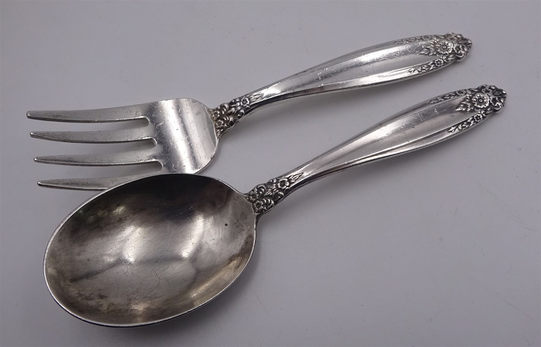 20th century American silver Prelude pattern baby spoon and fork set, with foliate detail to terminals, marked International Sterling Prelude, together with three further 20th century American silver baby spoons, the first example marked Gorham Sterling, and a pair marked International Sterling, approximate total silver weight 3.13 ozt (97.4 grams)