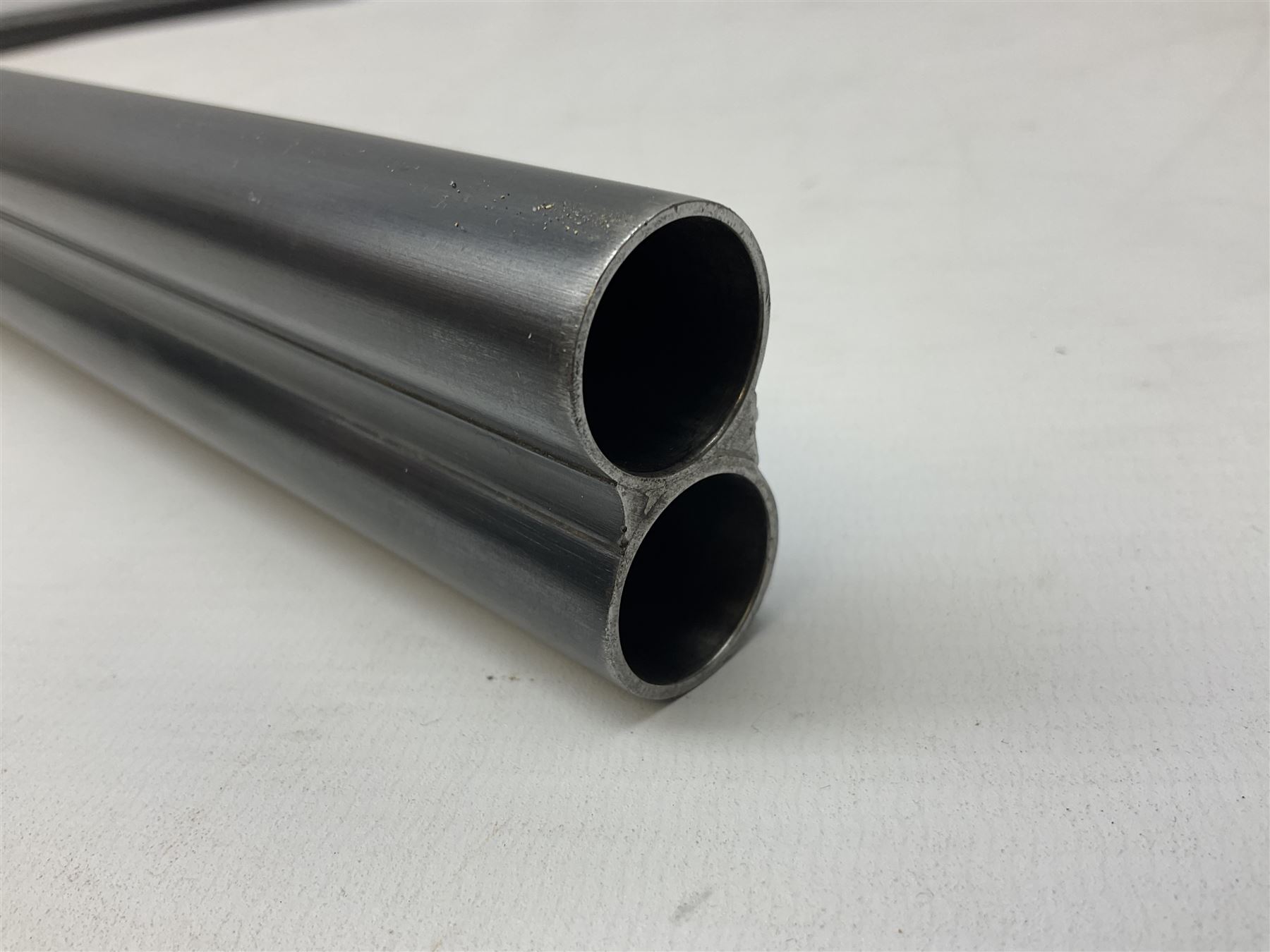 Smith Midgley Bradford 12-bore side-by-side double barrel side-lock ejector shotgun with 71cm barrels, engraved action with patented top lever, ivy leaf fences and top safety, walnut stock with chequered grip and fore-end, serial no.62409 to barrels and 1481 to action, L115cm overall SHOTGUN CERTIFICATE REQUIRED