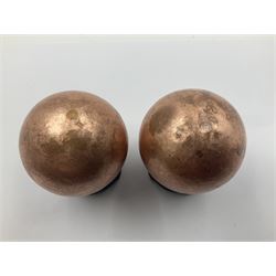 Pair of copper spheres, upon carved wooden bases, D5cm 