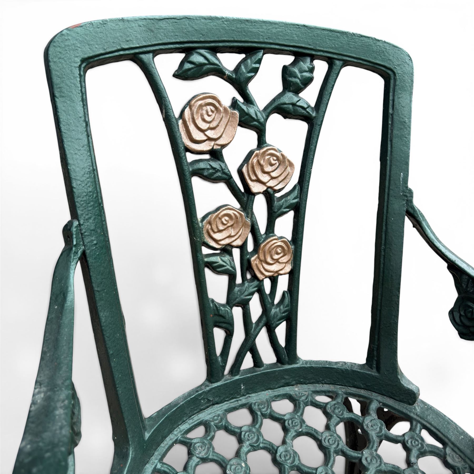 Cast aluminium oval garden table and set of four armchairs with pierced rose design back splats