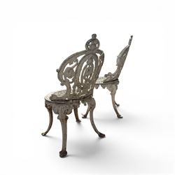 Pair of white painted cast metal garden chairs, ornate reclined backs, circular pierced seats on cabriole legs